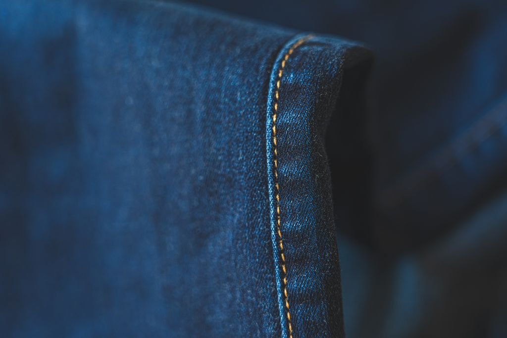 Dettaglio di cuciture su denim con orlo svelto